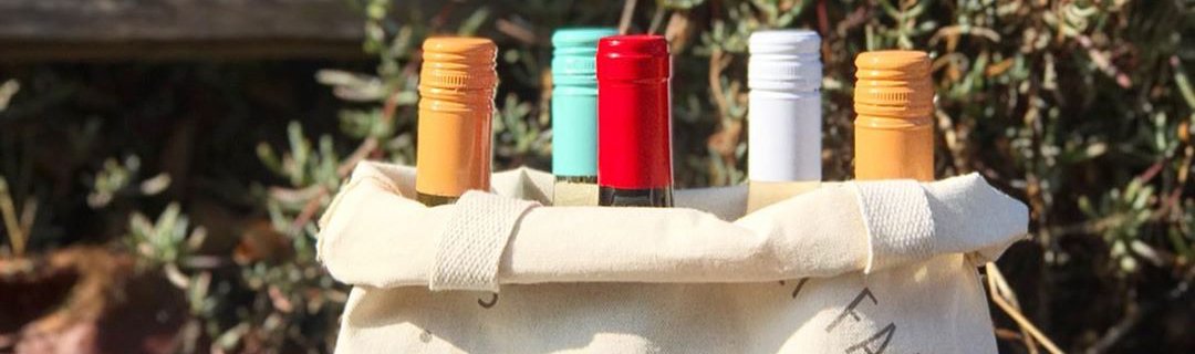 a bunch of Obvious Wines bottles in a cloth sack