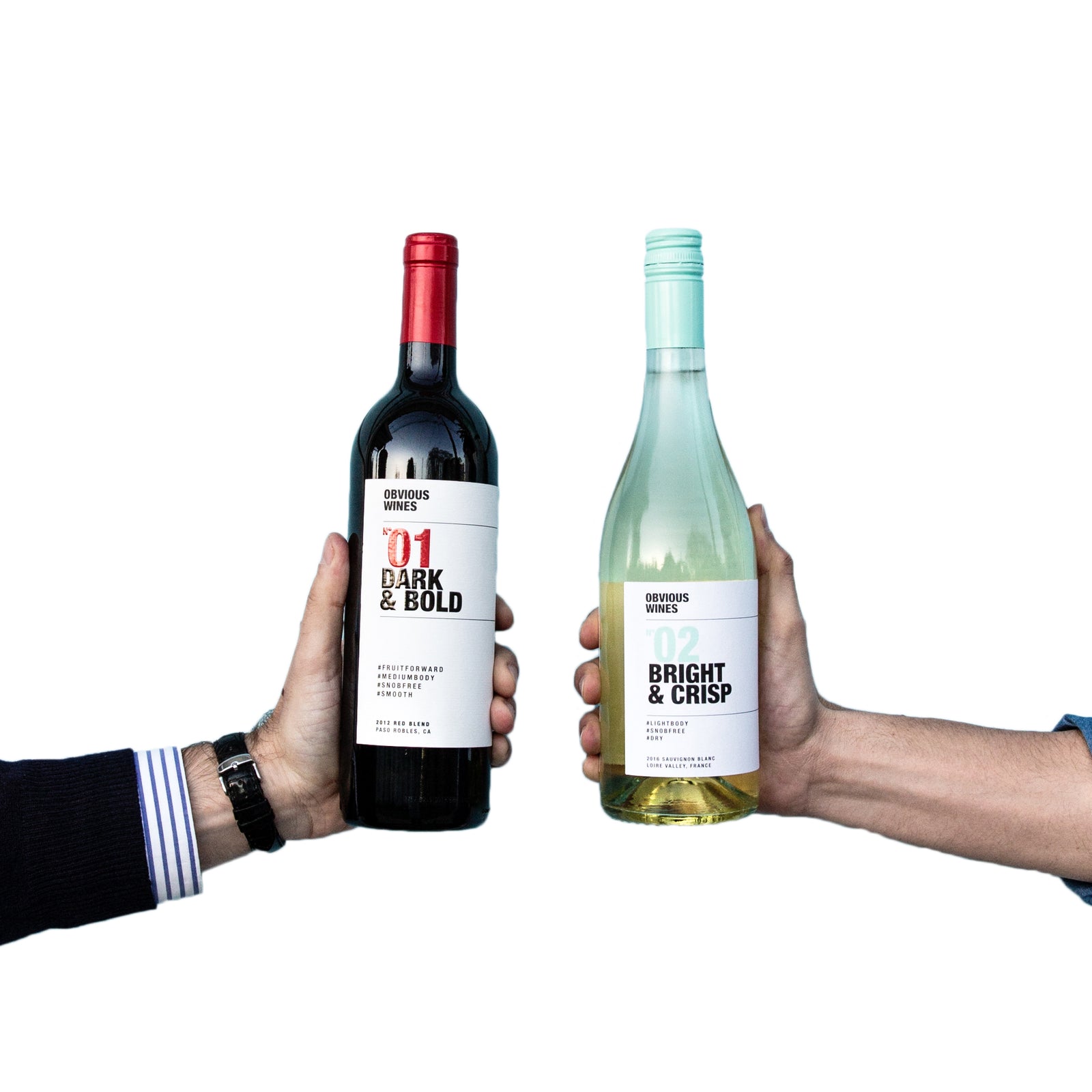 Two Obvious Wines bottles being held next to eachother